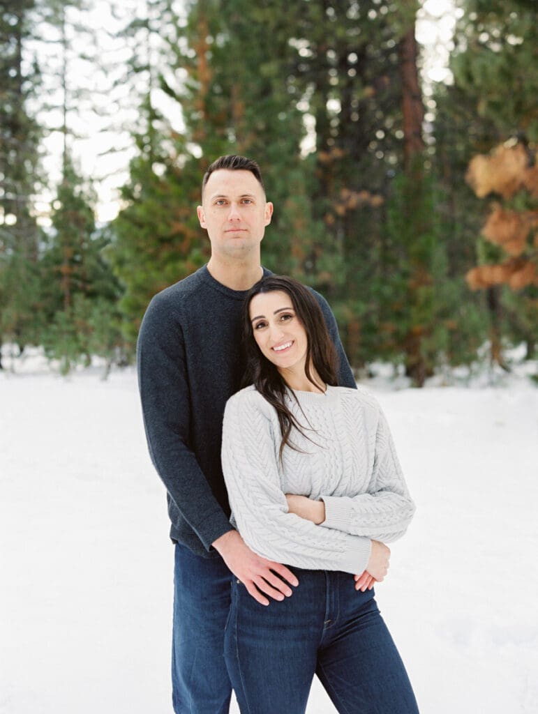 A snowy engagement session in Lake Tahoe, showcasing a couple joyfully celebrating their love in a winter wonderland.