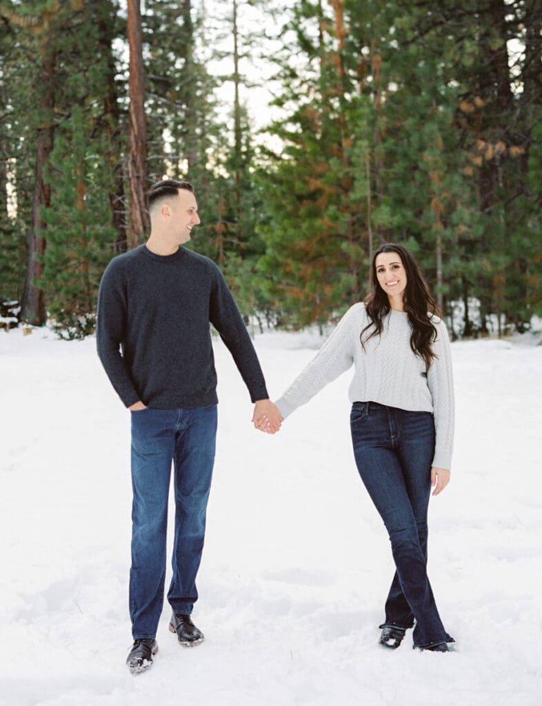 A snowy romantic engagement session in Tahoe, featuring a couple amidst a picturesque snowy backdrop, capturing their love.