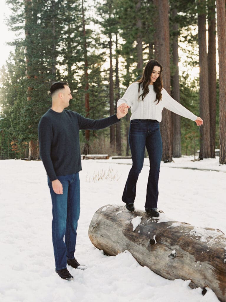 A snowy romantic engagement session in Tahoe, featuring a couple amidst a picturesque snowy backdrop, capturing their love.