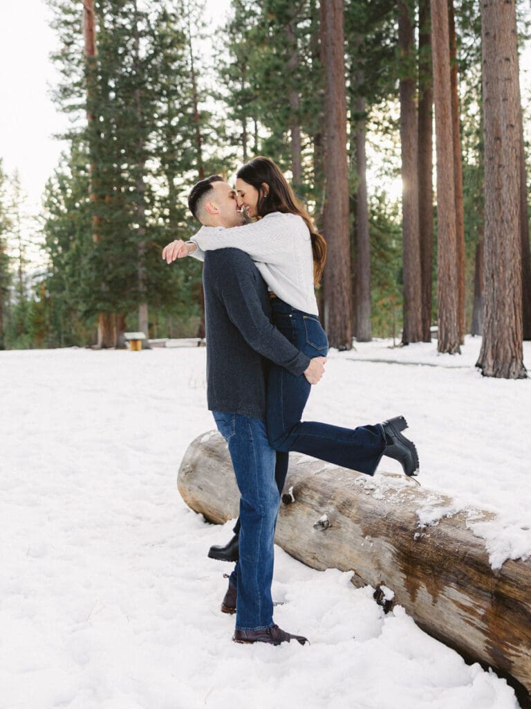 A snowy romantic engagement session in Tahoe, featuring a couple amidst a picturesque snowy backdrop, capturing their love.