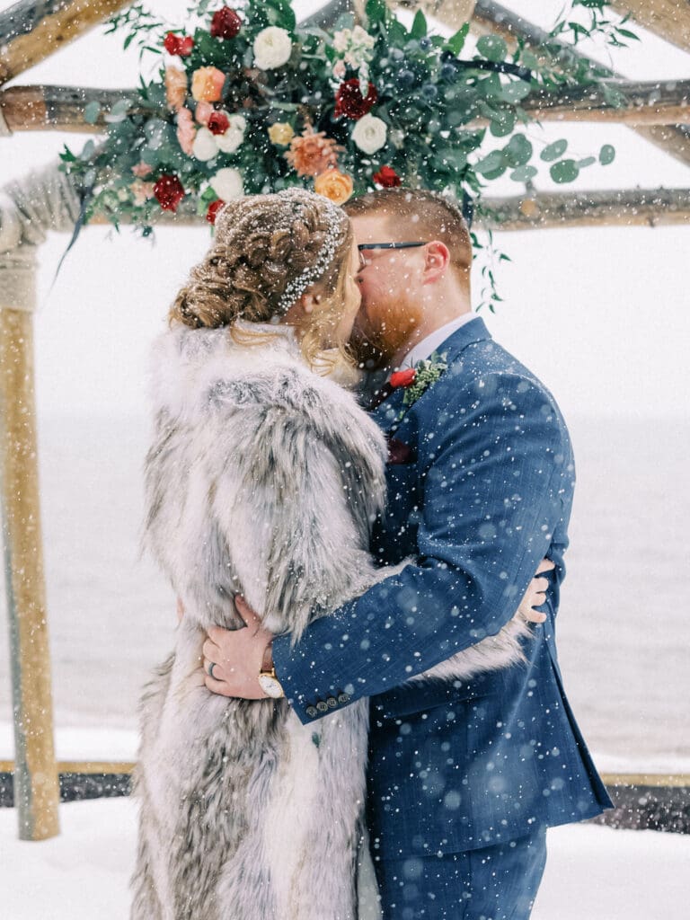 First kiss at Cozy Lake Tahoe Winter Wedding