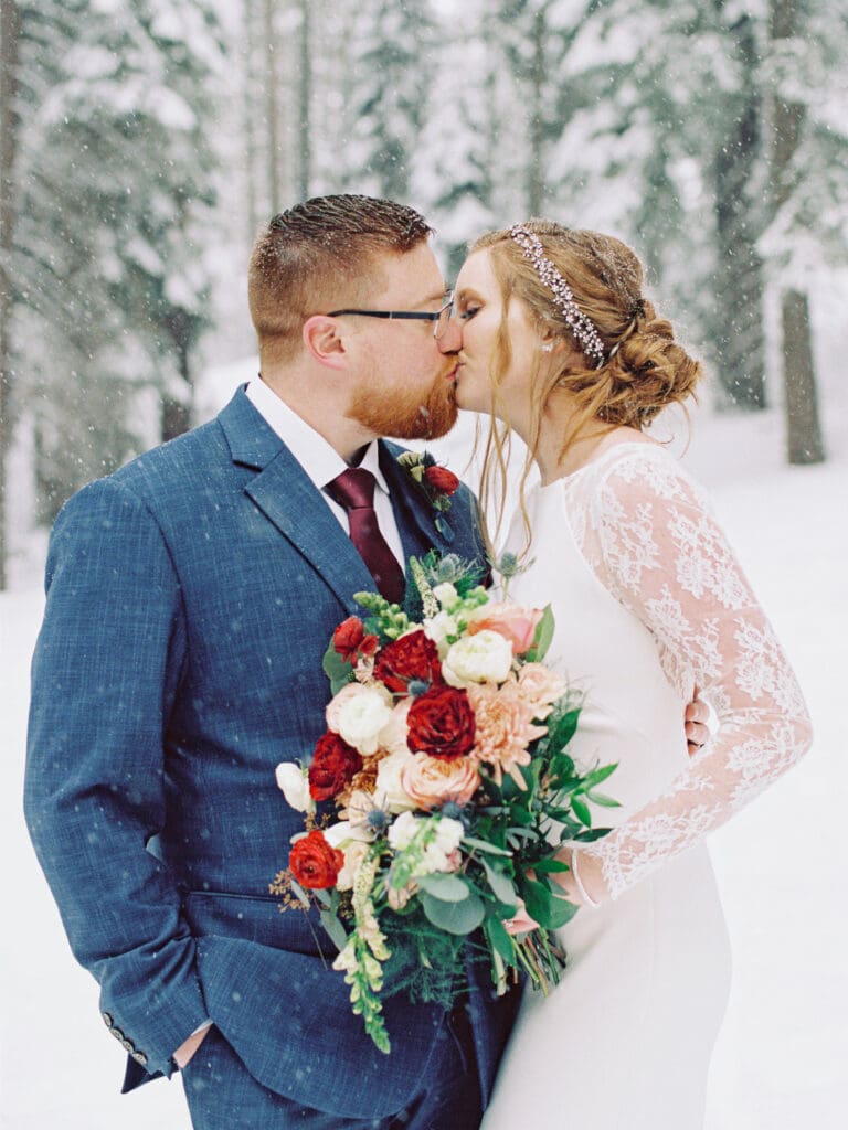 Bride and Groom kiss at Cozy Lake Tahoe Cabin Winter Wedding