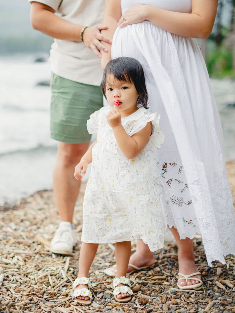 A family photo session at Lake Tahoe featuring a man, a woman, and a little girl standing together.