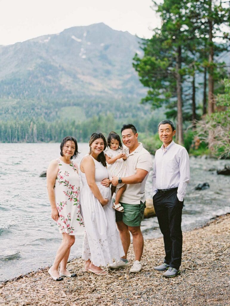 A family poses together for a photo by the lake during their photography session in South Lake Tahoe.