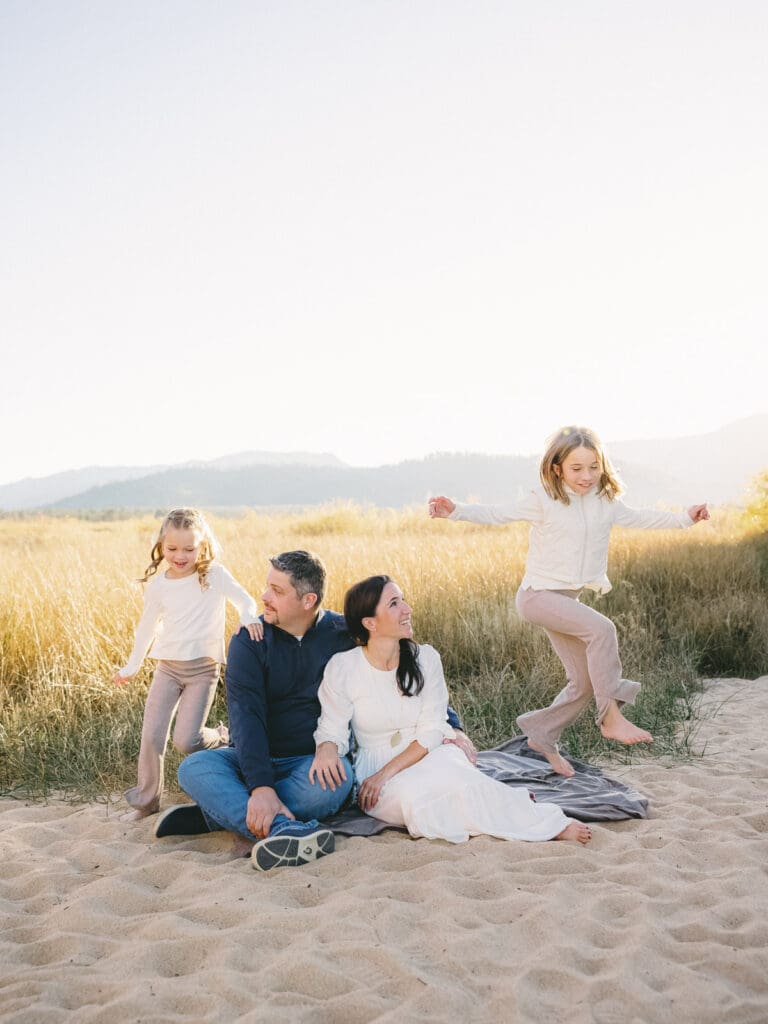 A family enjoys a beach in South Lake Tahoe, capturing moments during their family photo session.