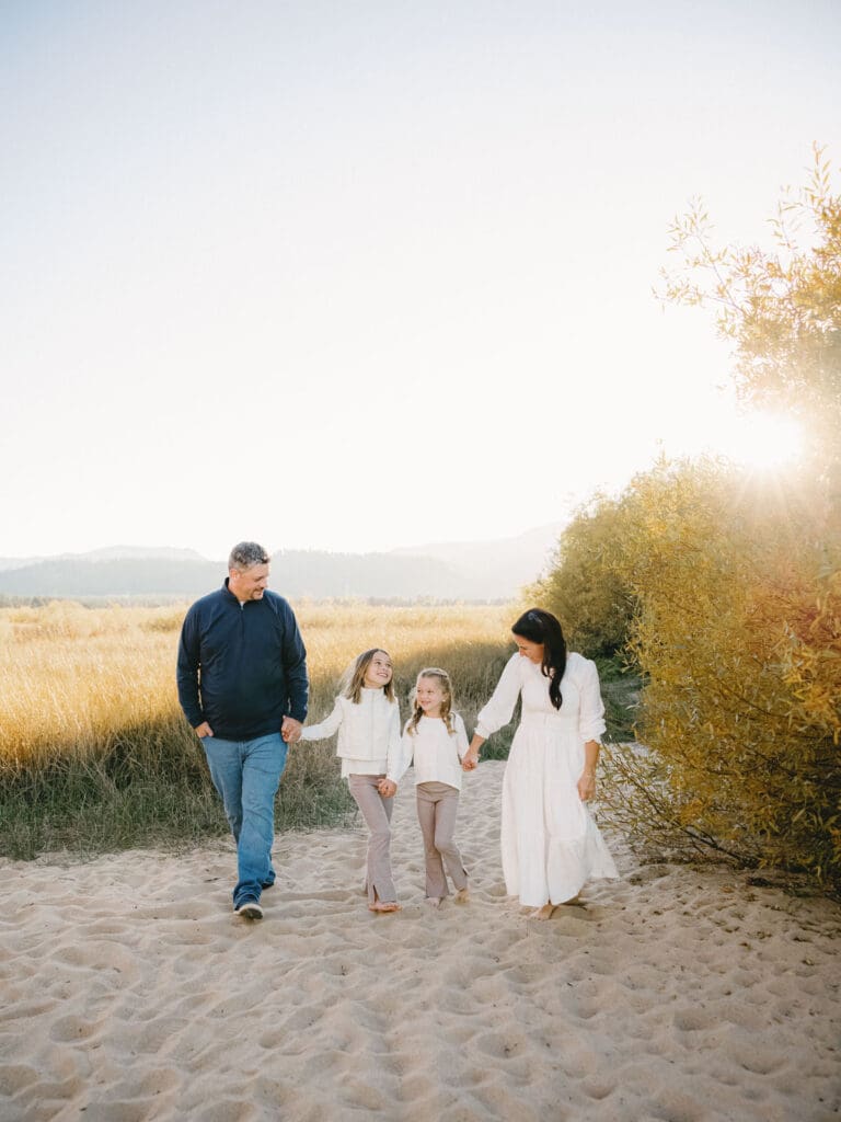 A family enjoys a beach walk in South Lake Tahoe, capturing moments during their family photo session.