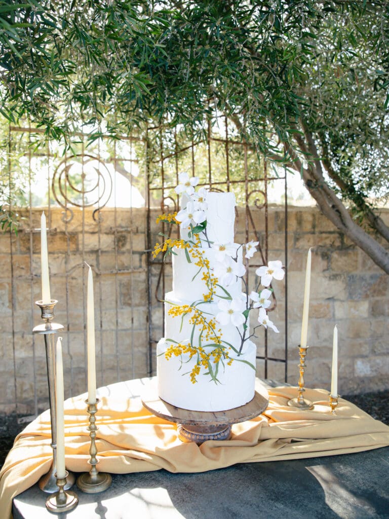 Stunning simplistic and elegant wedding cake in yellow color at Sunstone Villa - Sunstone Winery and Vineyards wedding