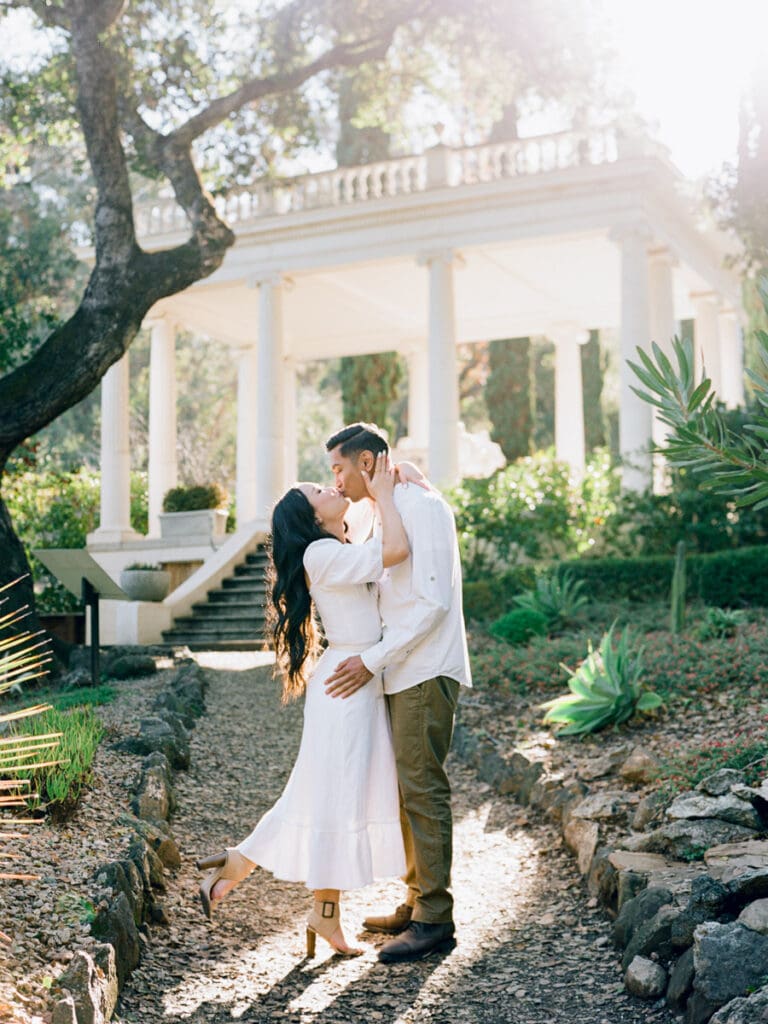 A couple celebrates their engagement at Villa Montalvo in San Francisco, framed by picturesque landscapes and vibrant flora.