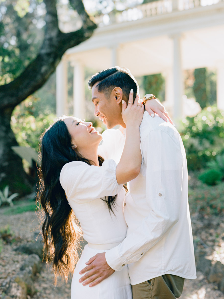 A couple celebrates their engagement at Villa Montalvo in San Francisco, framed by picturesque landscapes and vibrant flora.