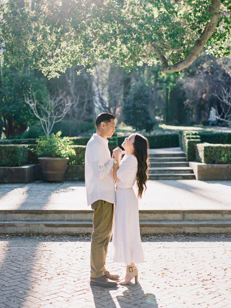 Couple gazing into each others eyes at romantic Villa Montalvo engagement session in San Francisco, showcasing a couple's love amidst stunning landscapes.