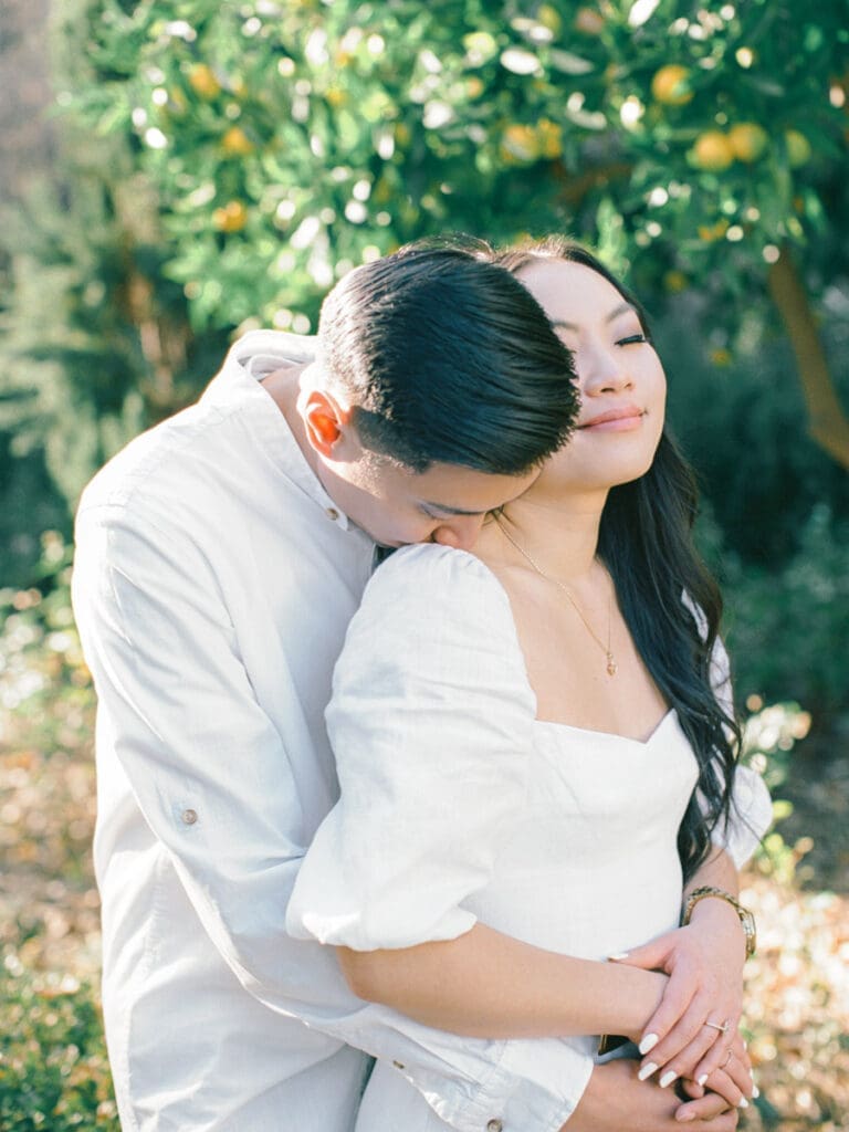 Couple embracing at romantic Villa Montalvo engagement session in San Francisco, showcasing a couple's love amidst stunning landscapes.