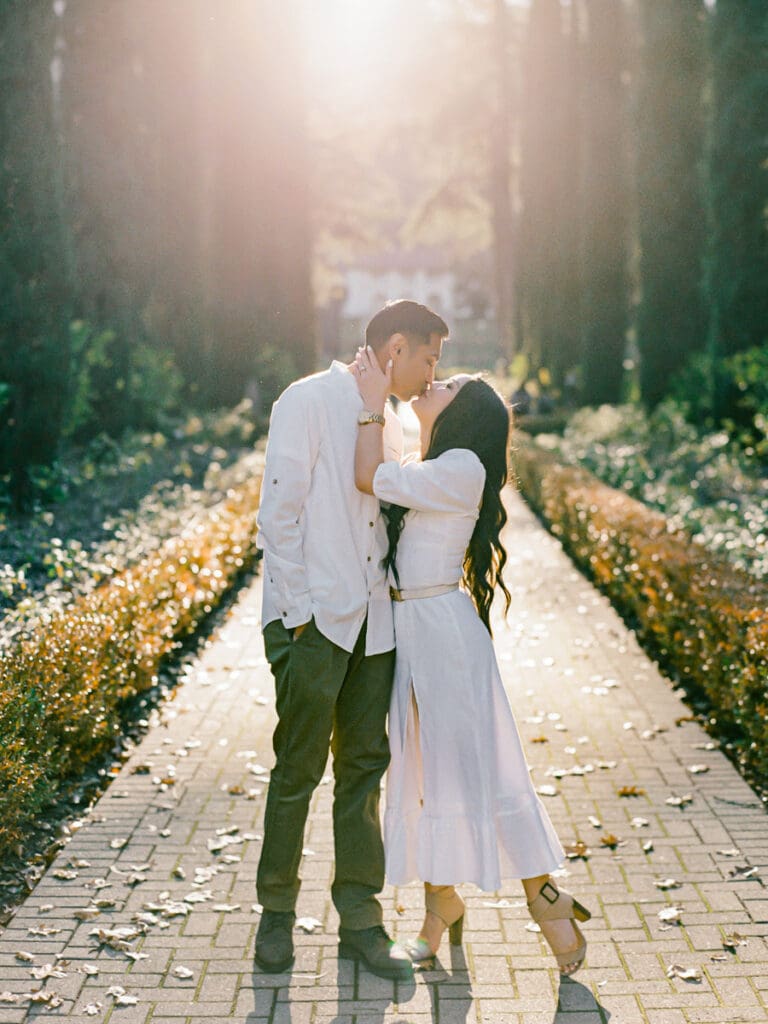 Couple kissing at romantic Villa Montalvo engagement session in San Francisco, showcasing a couple's love amidst stunning landscapes.