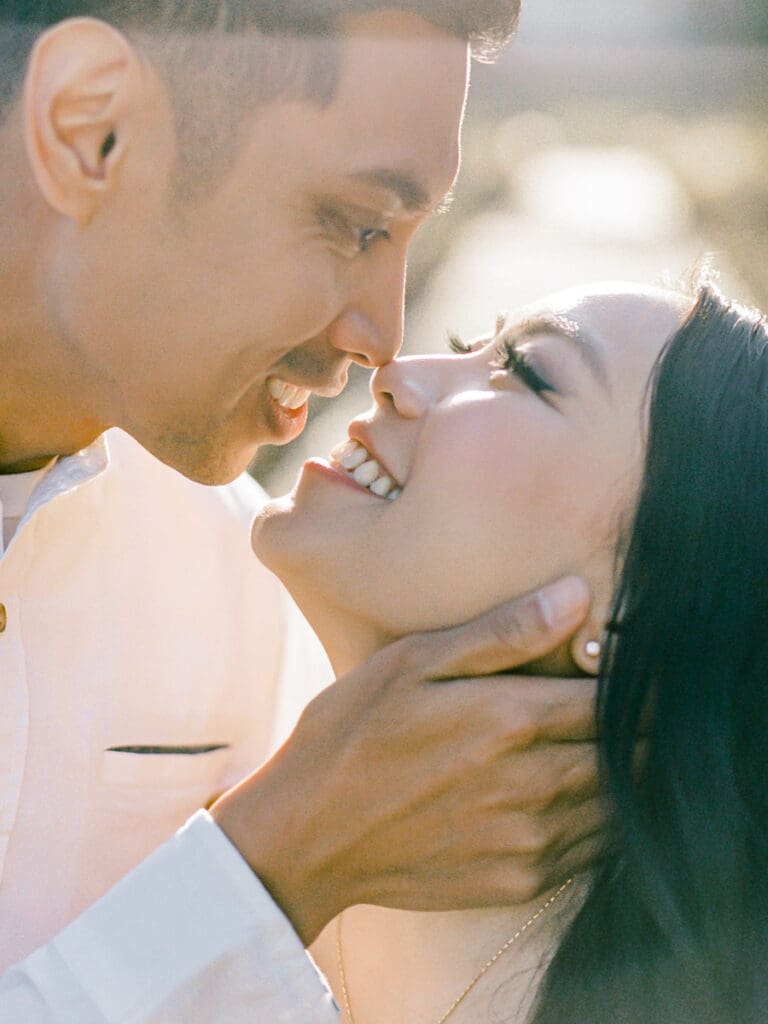 Couple gazing into each others eyes at romantic Villa Montalvo engagement session in San Francisco, showcasing a couple's love amidst stunning landscapes.