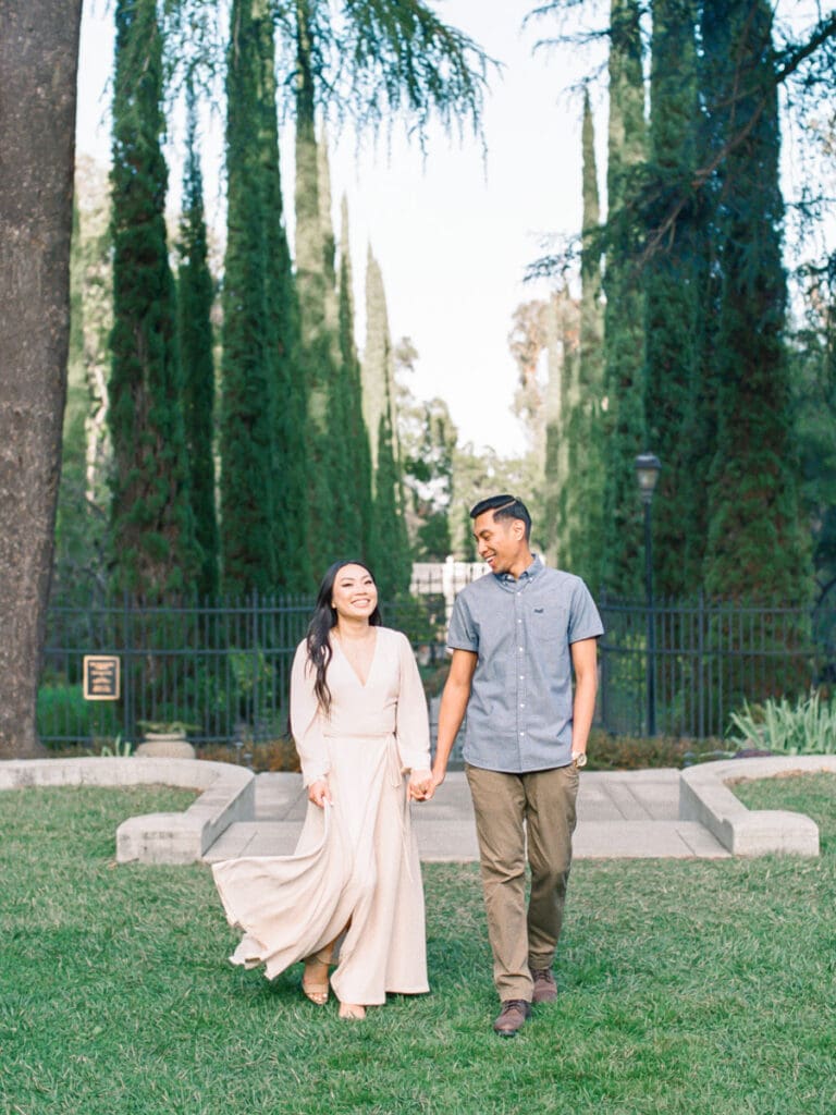 Couple walking at romantic Villa Montalvo engagement session in San Francisco, showcasing a couple's love amidst stunning landscapes.