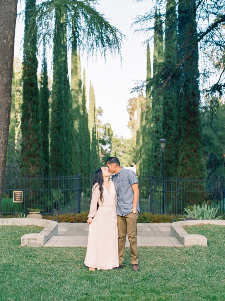 Couple kissing at romantic Villa Montalvo engagement session in San Francisco, showcasing a couple's love amidst stunning landscapes.